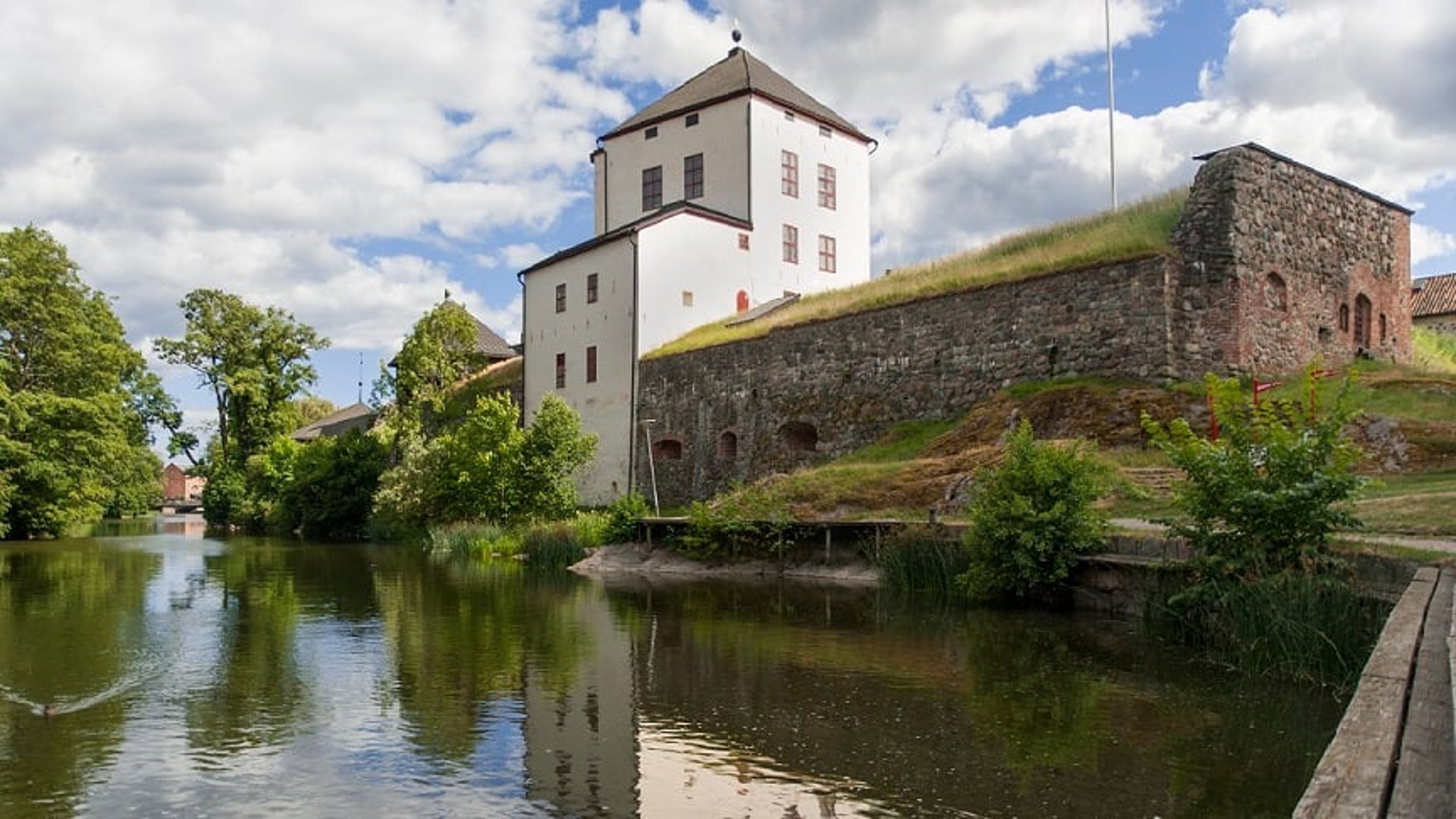 Nyköpingshus med Nyköpingsån i förgrunden.